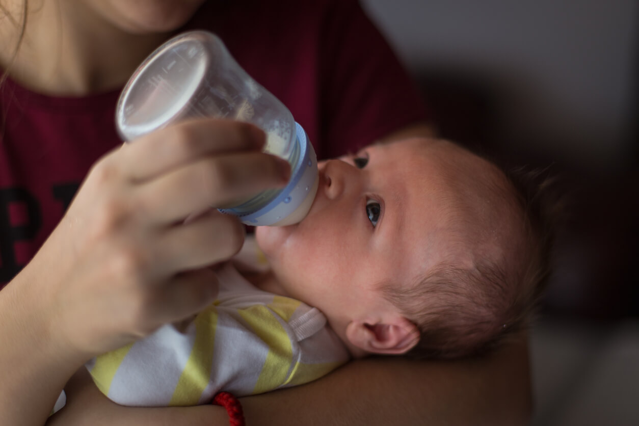 A newborn drinking from a bottle.