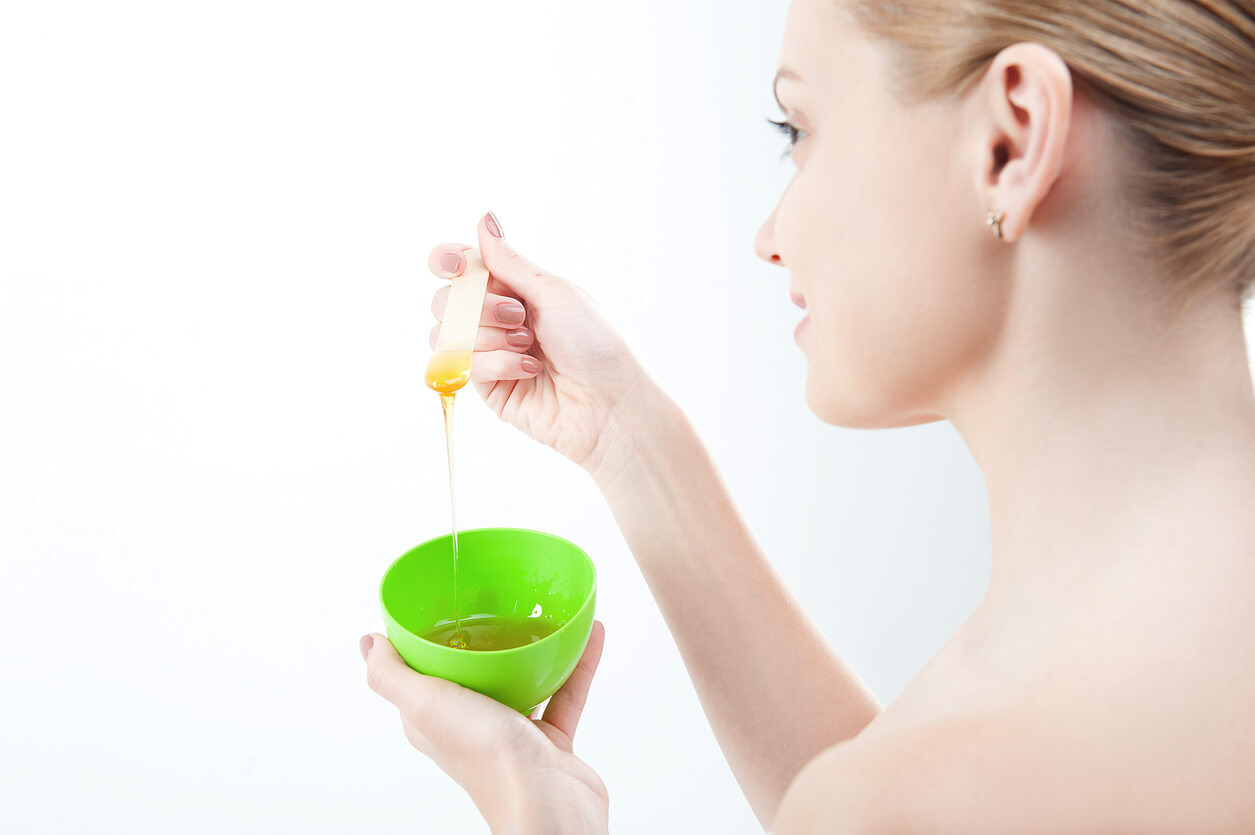 A woman preparing a honey mask.