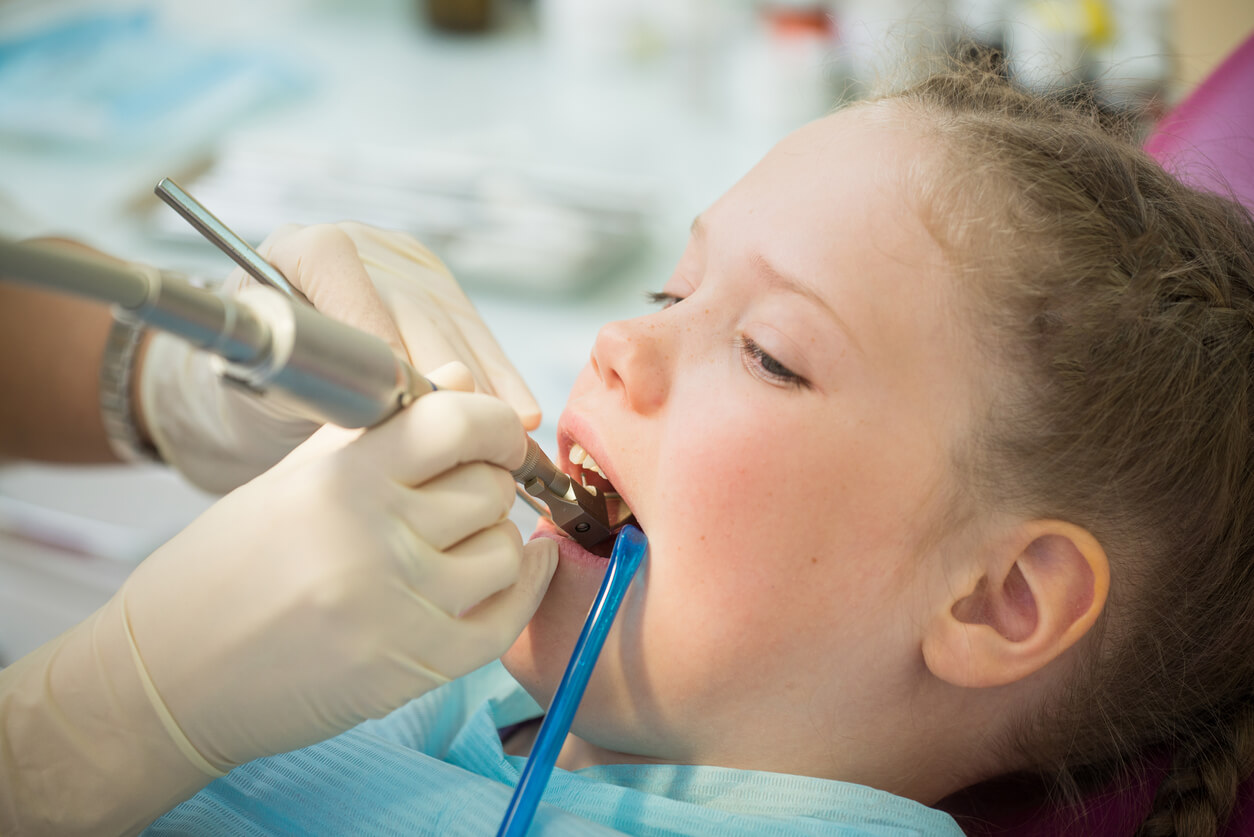 A young girl at the dentist.