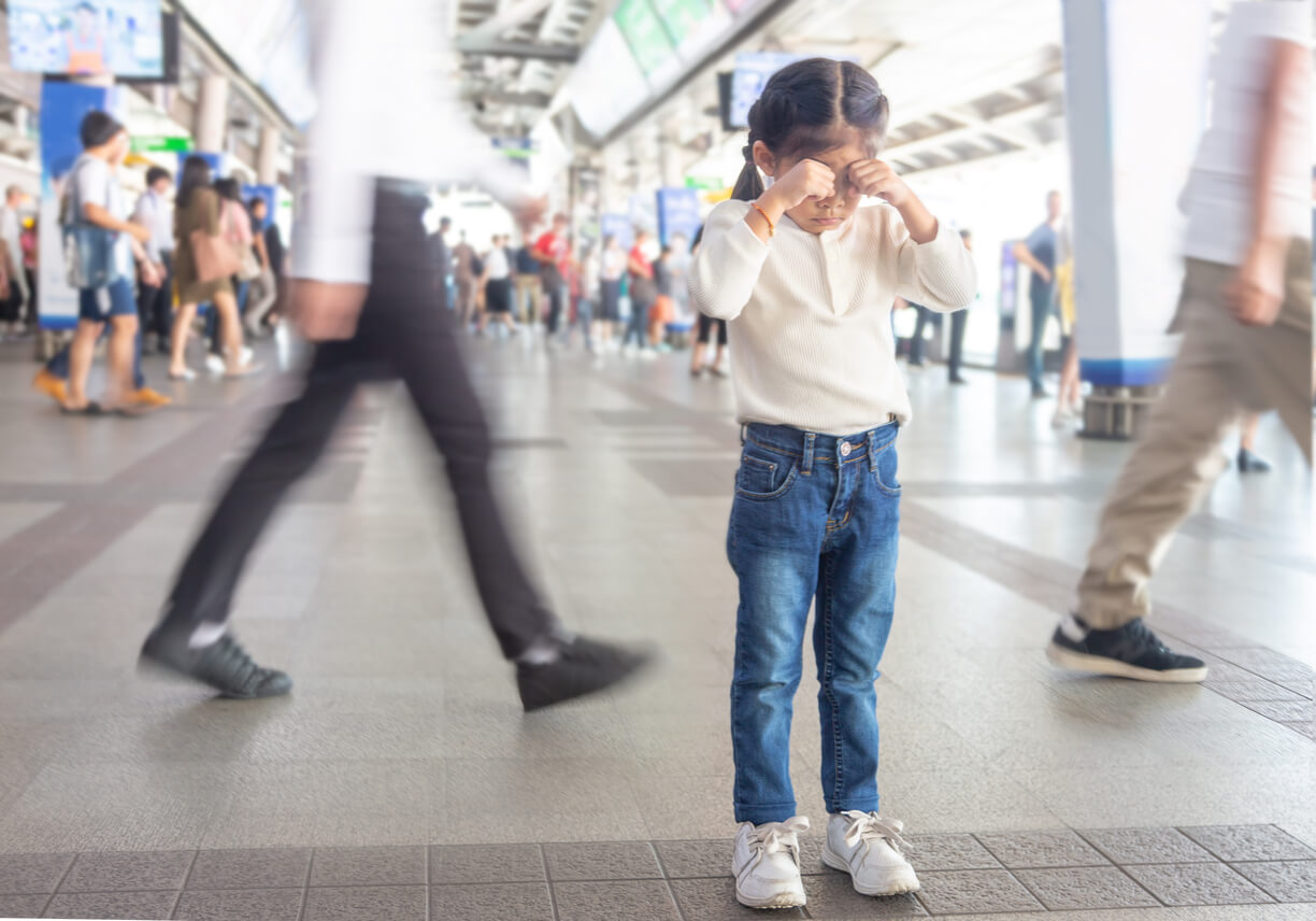 A young girl cyring because she's lost in a public space.