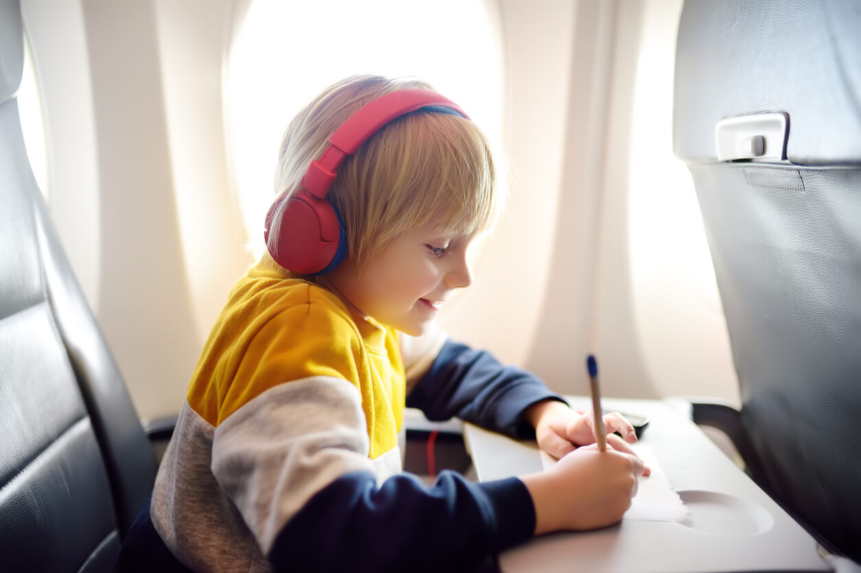 A child drawing while traveling by air.