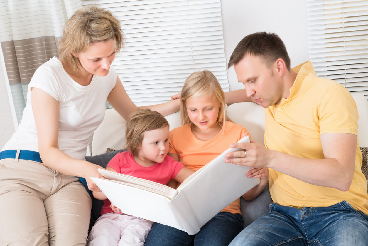 A family looking at a family photo album.