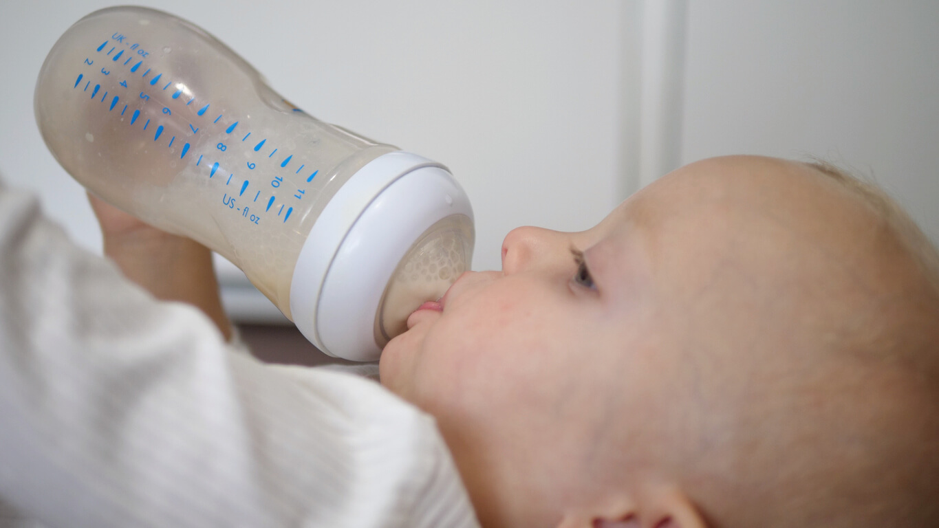 A baby drinking from a bottle.