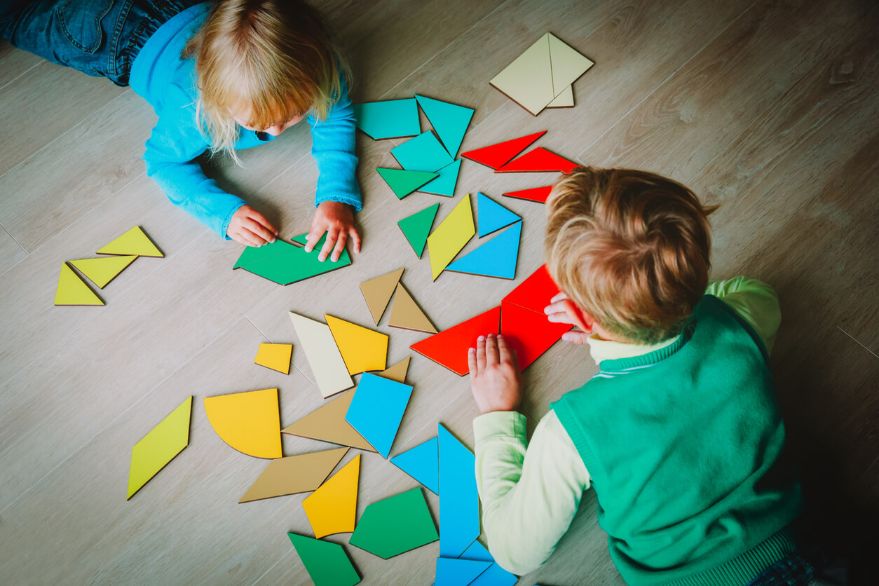 Children playing with tangram pieces.