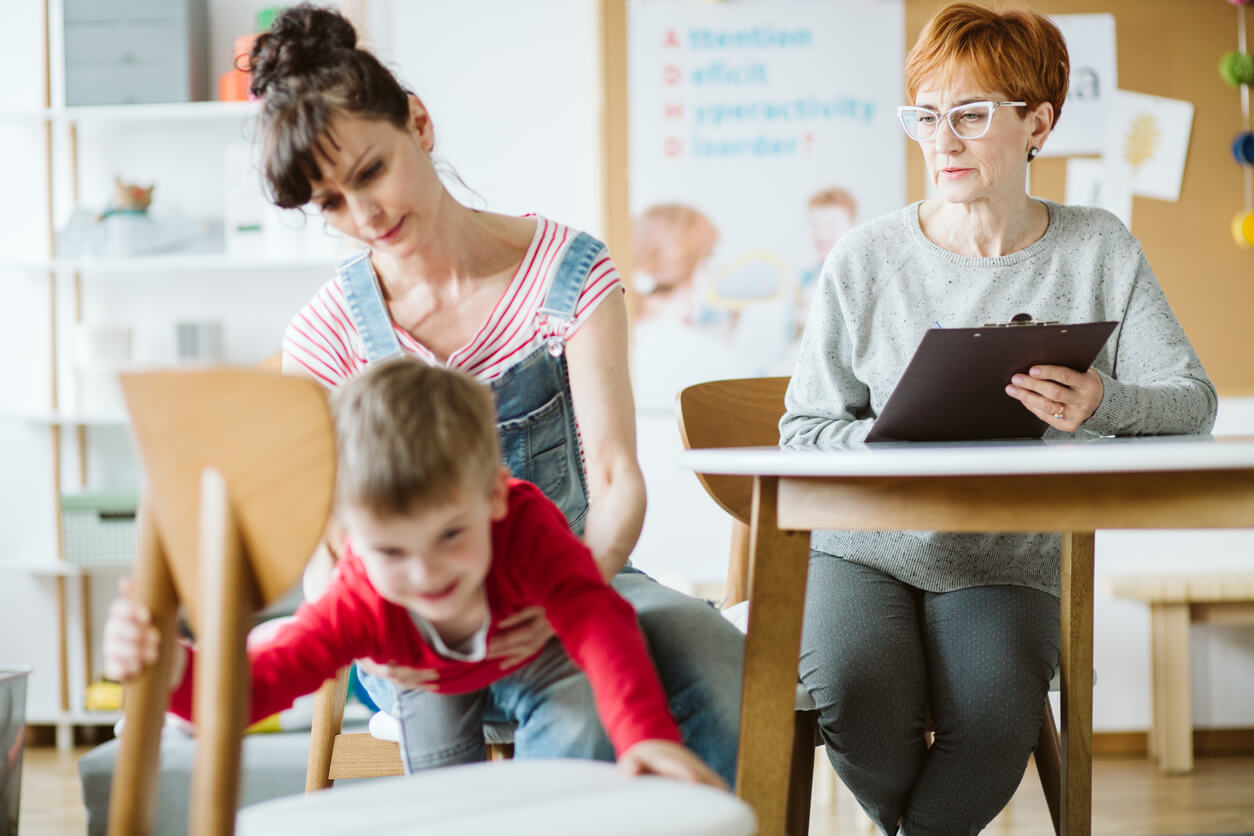 A child with ADHD escaping from a table during a therapy session.