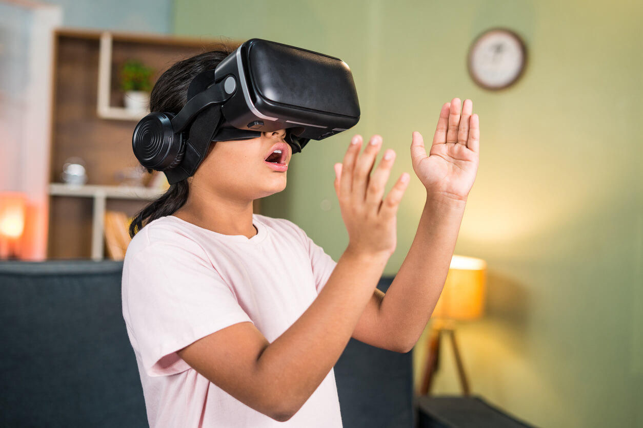 A young girl wearing a virtual reality headset.
