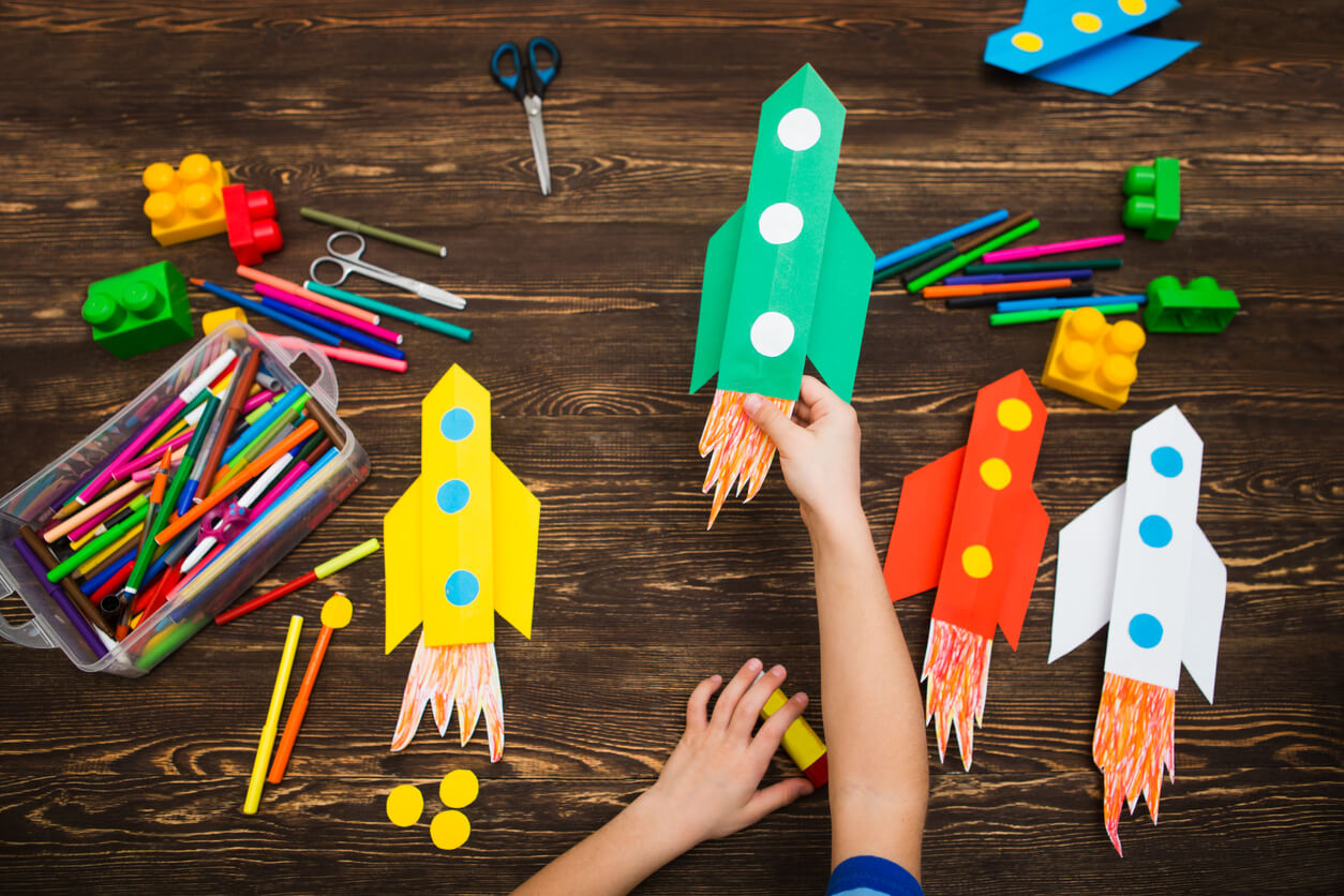 A child making paper rockets.