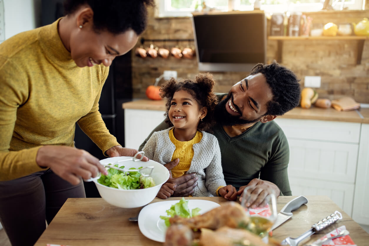 A black family sitting down for a family meal.
