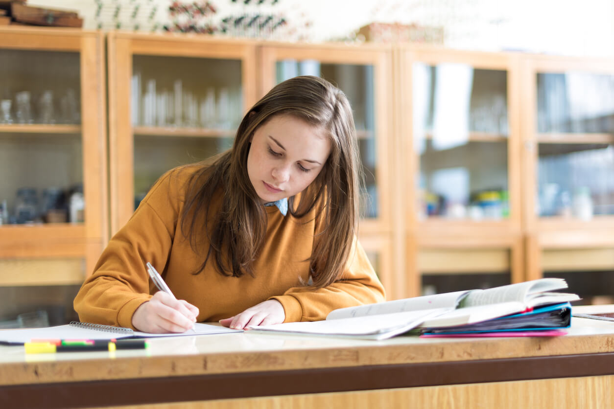 A teenage girl doing school work.