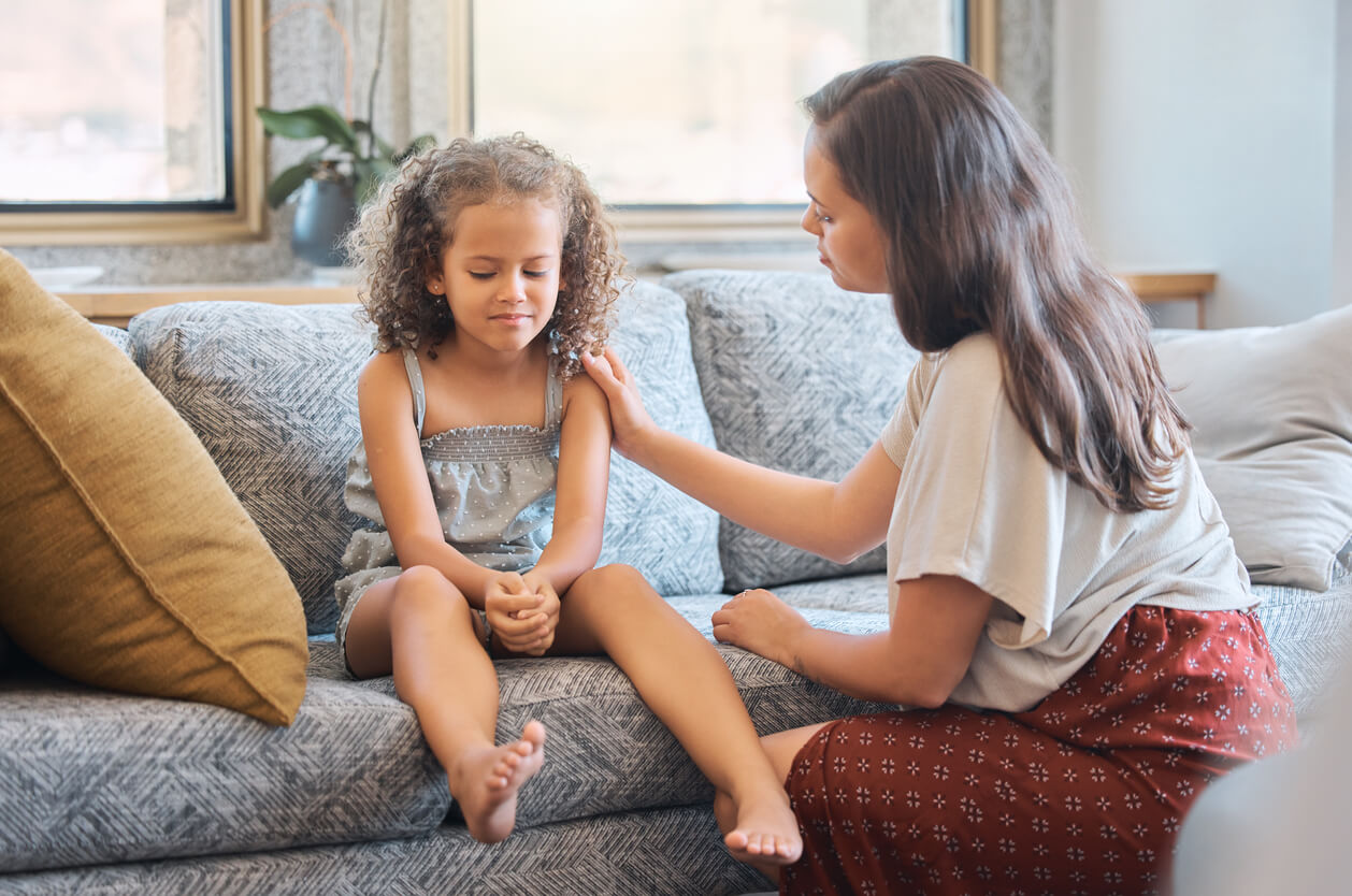 A mother having a difficult conversation with her young daughter.