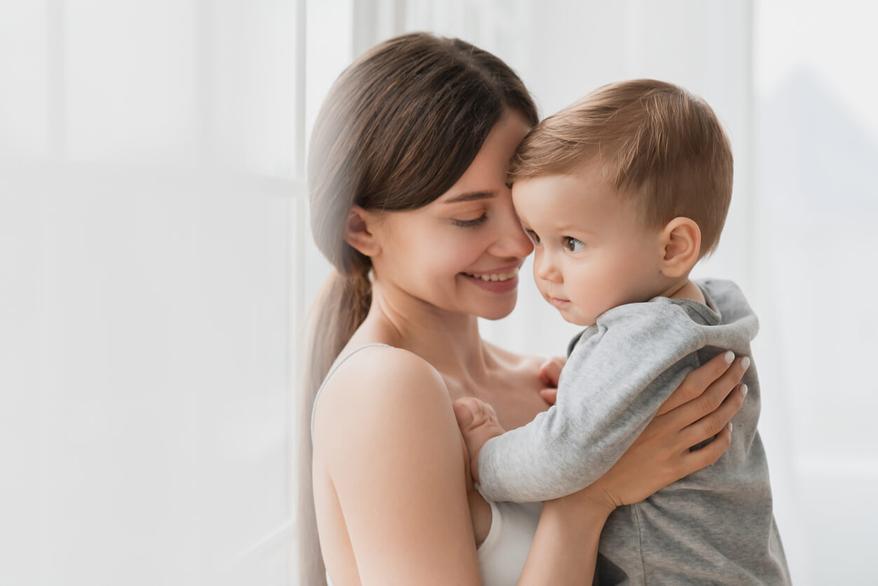 A mother holding her baby boy.