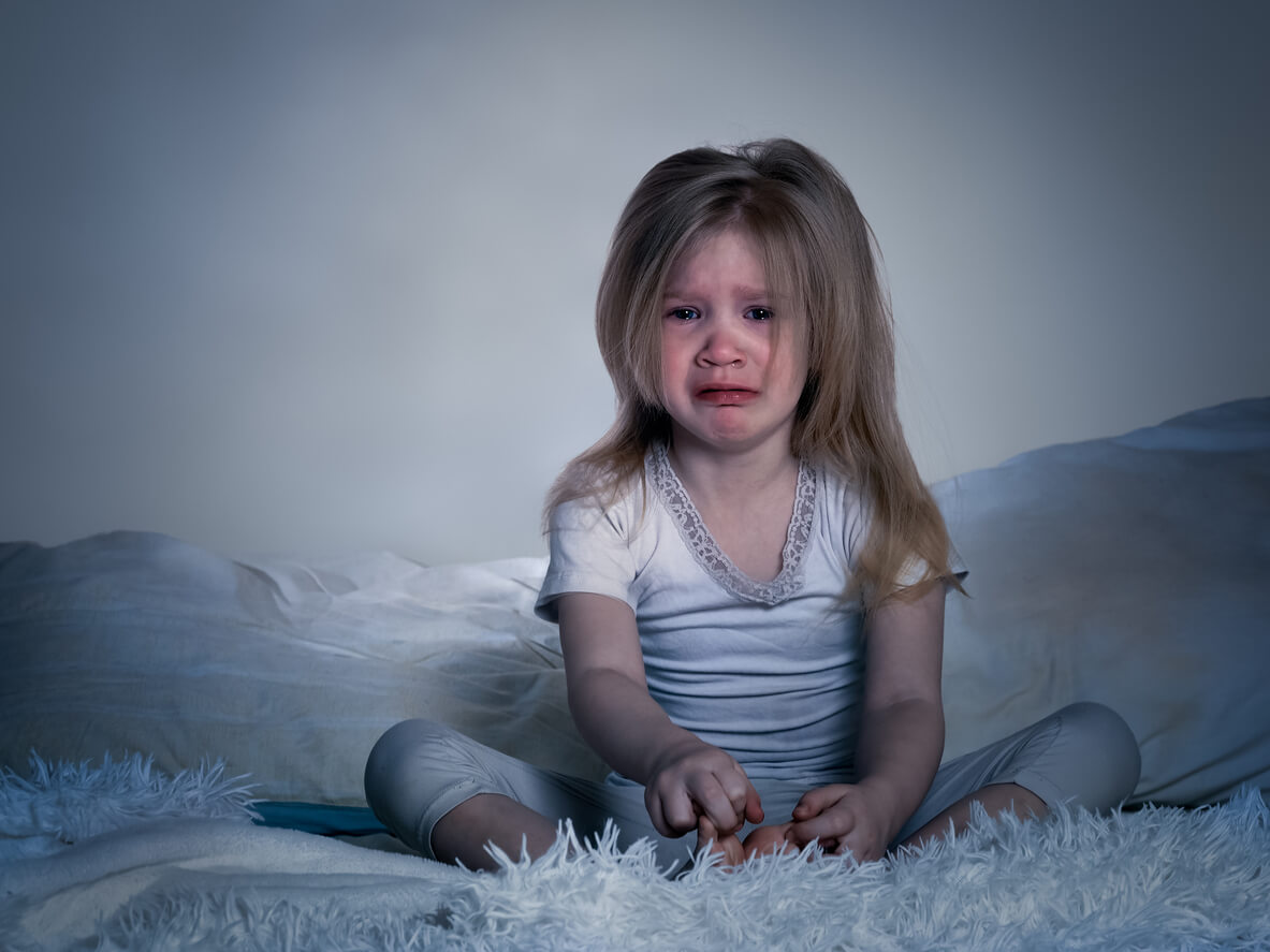 A little girl who's woken up crying during the night.