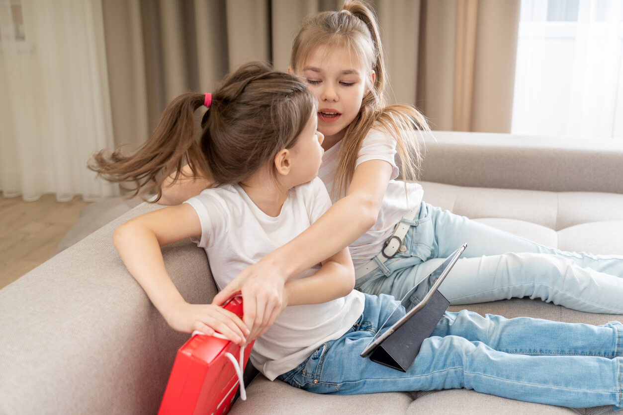 Two sisters fighting over a gift.
