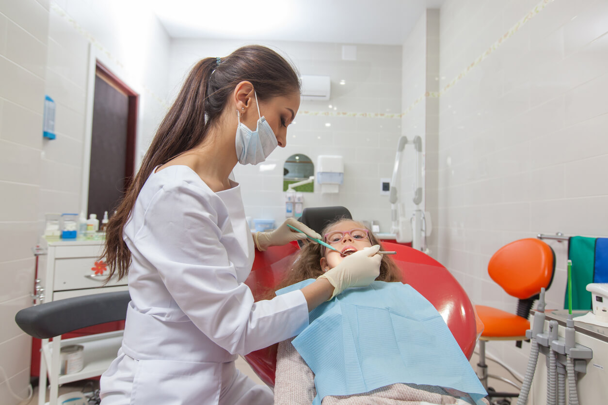 A young girl undergoing dental treatment.