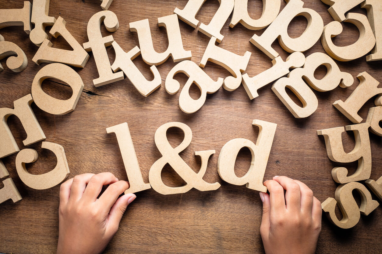 A child playing with wooden letters.