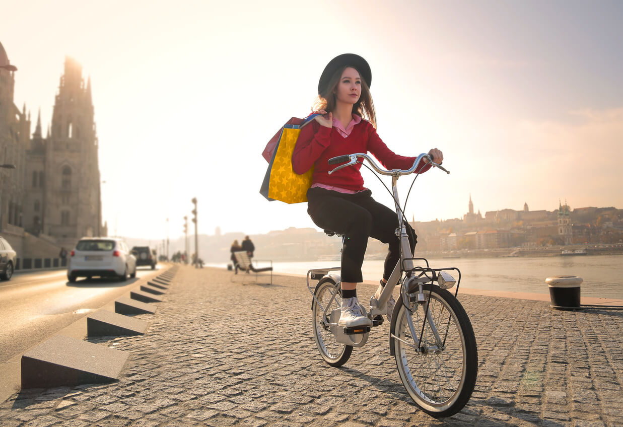 A young woman riding a bike in Budapest.