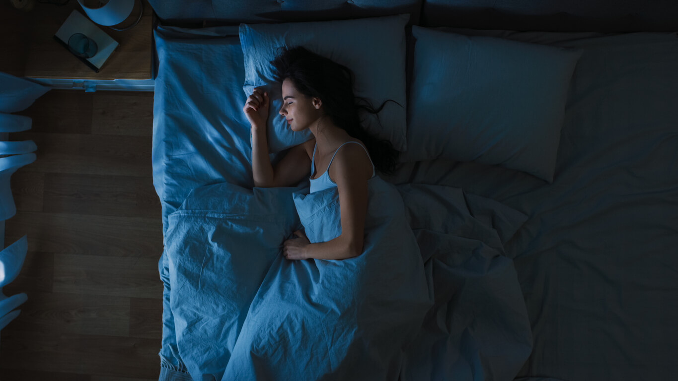 A teenage girl sleeping peacefully in bed.