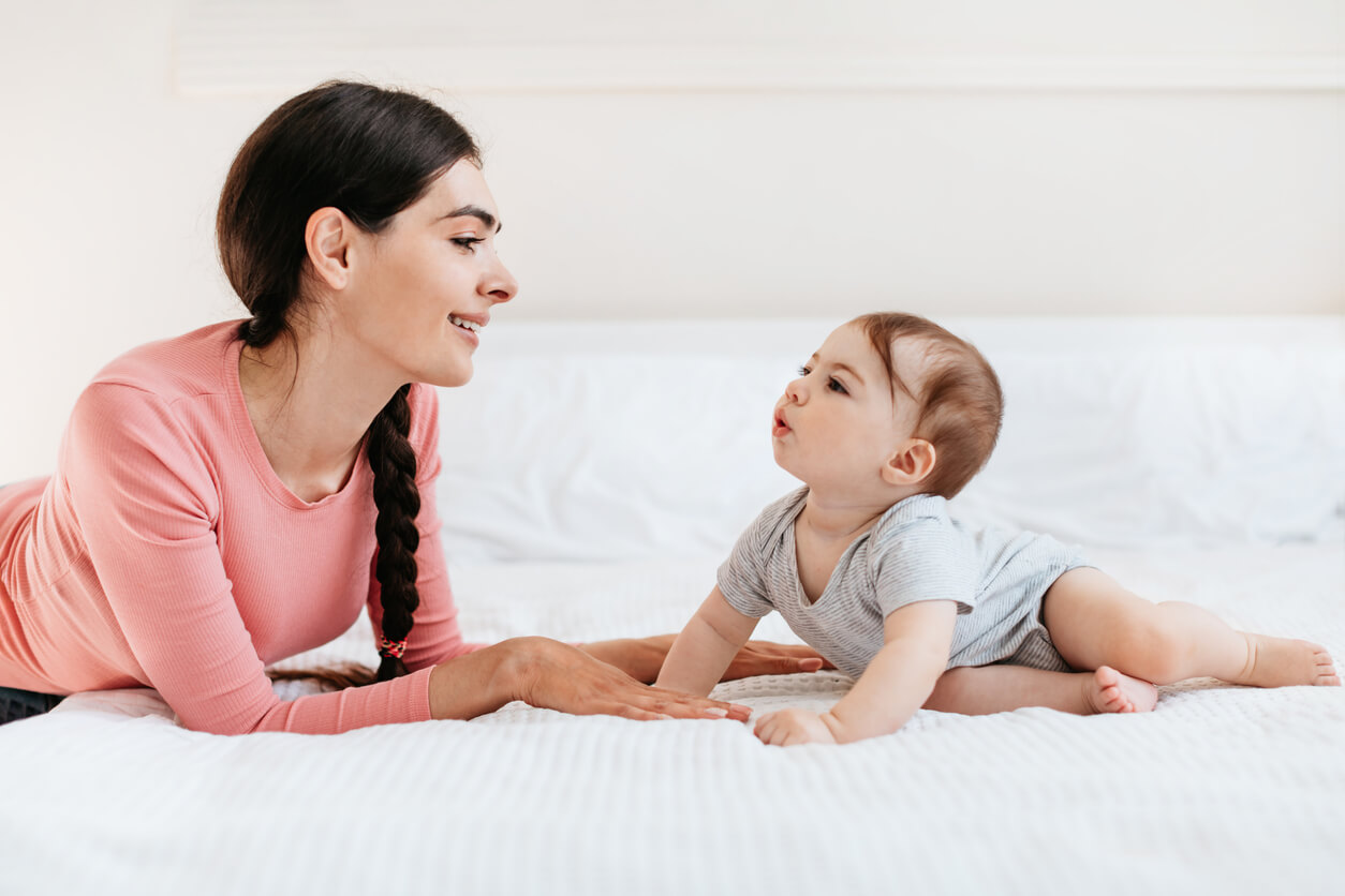 A mother talking to her little baby.