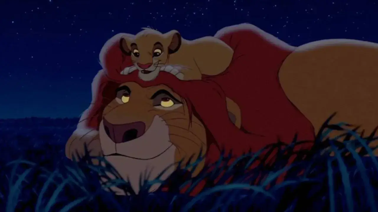 Mufasa and Simba talking in the grass under the night sky.