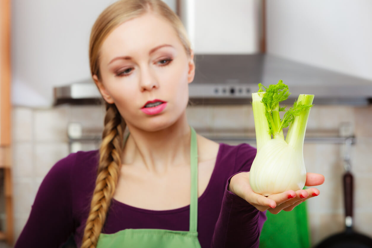 A woman holding a fennel plant.