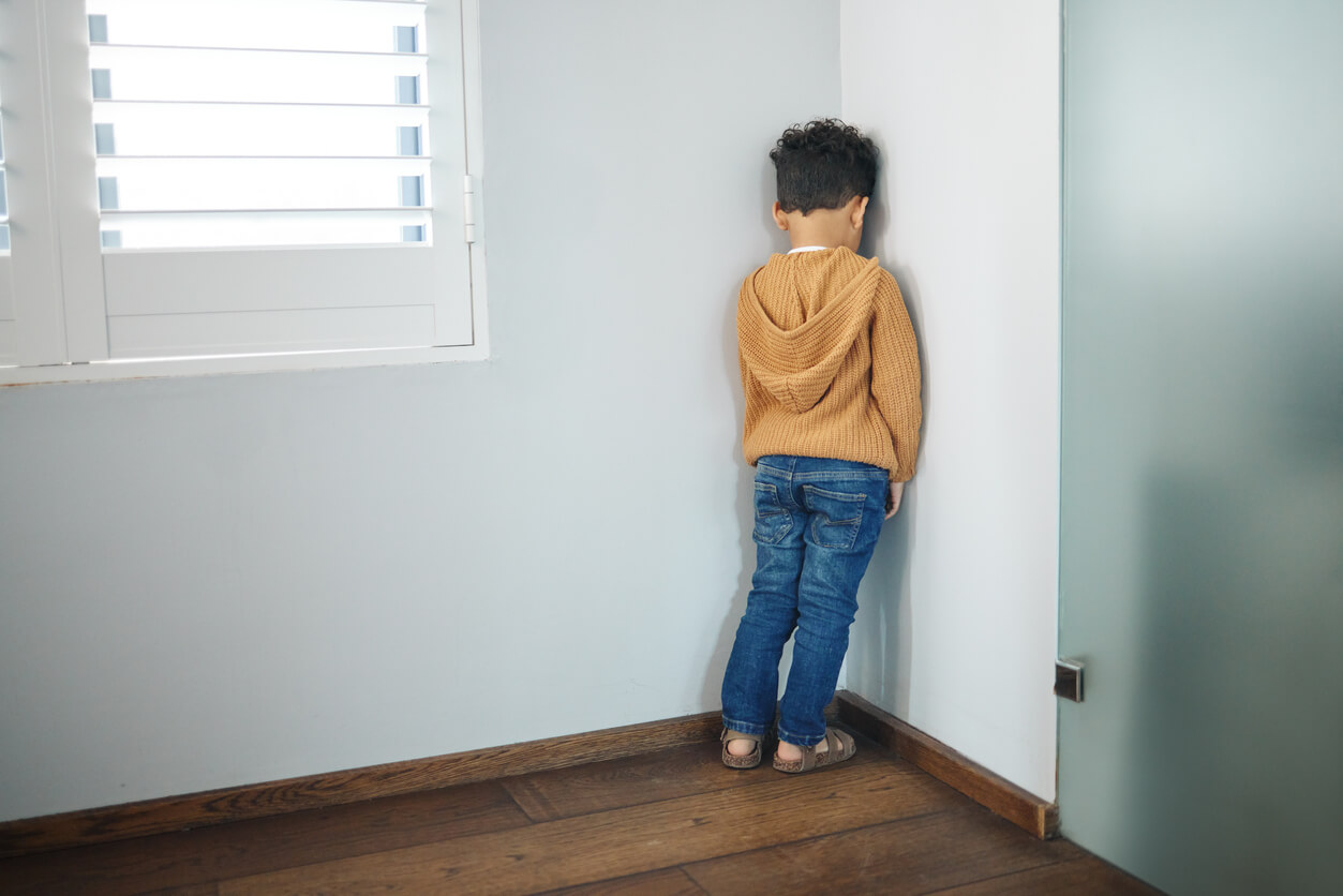 A child standing in a corner.