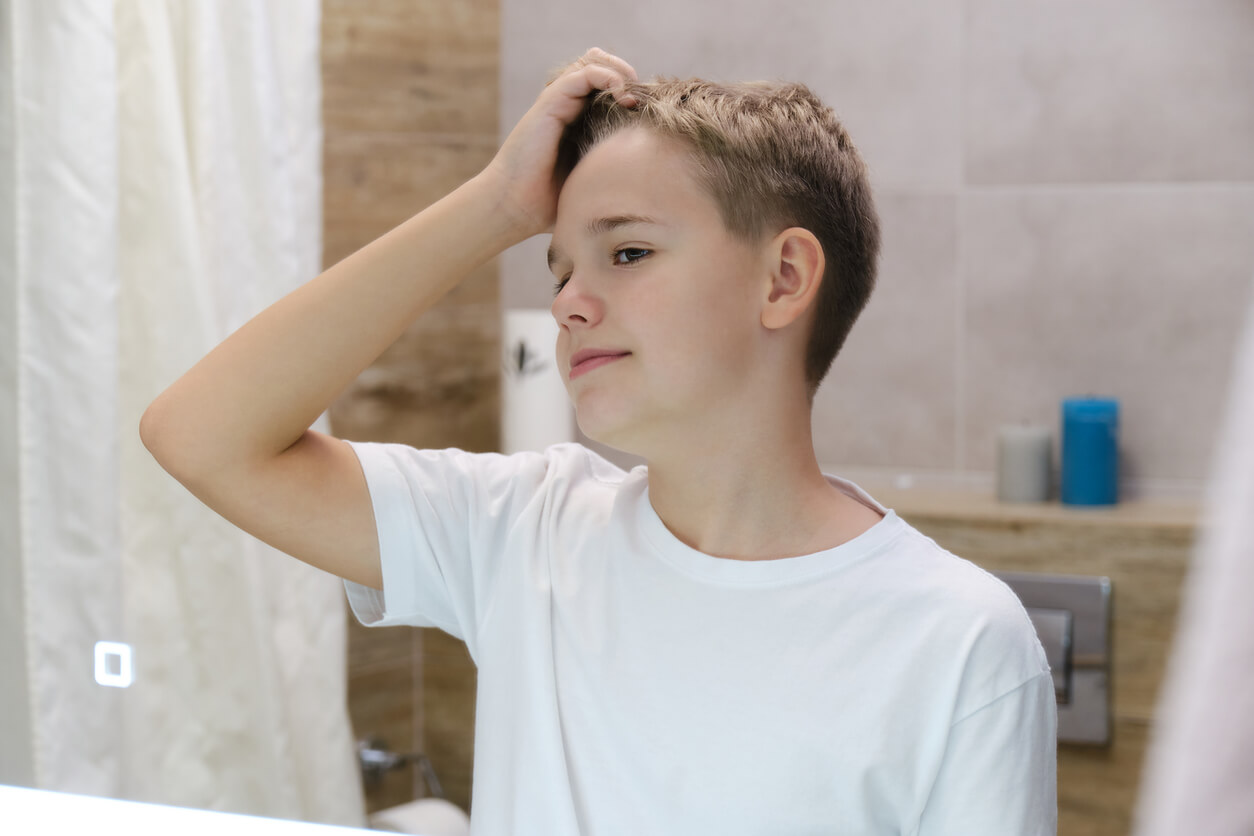 An arrogant pre-teen admiring himself in the mirror.