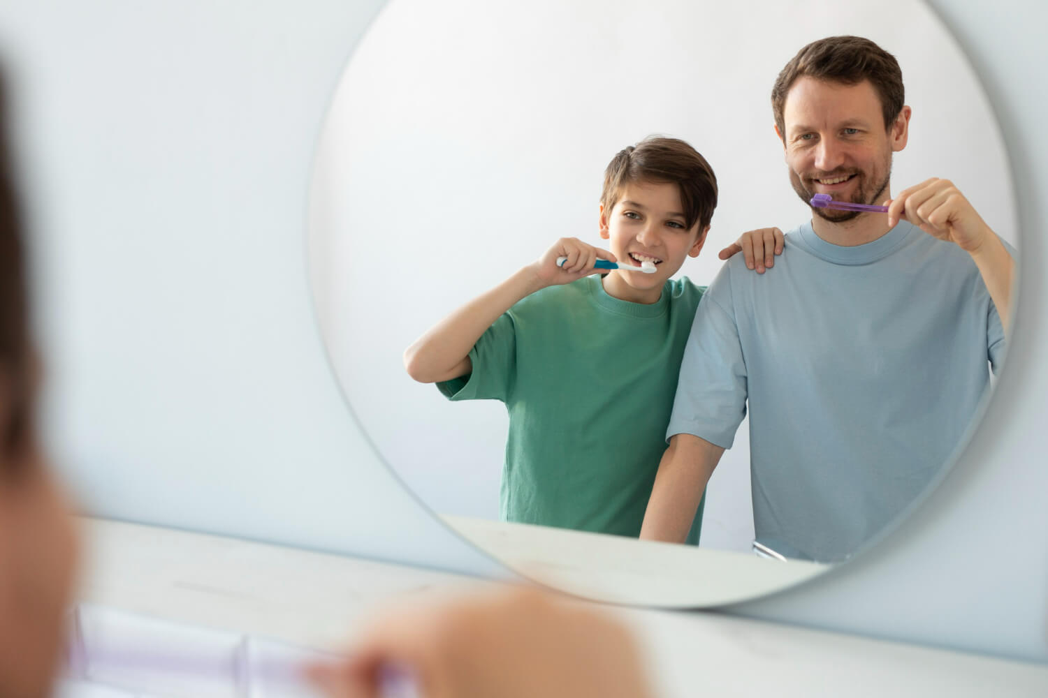 Père et fils se brossant les dents.