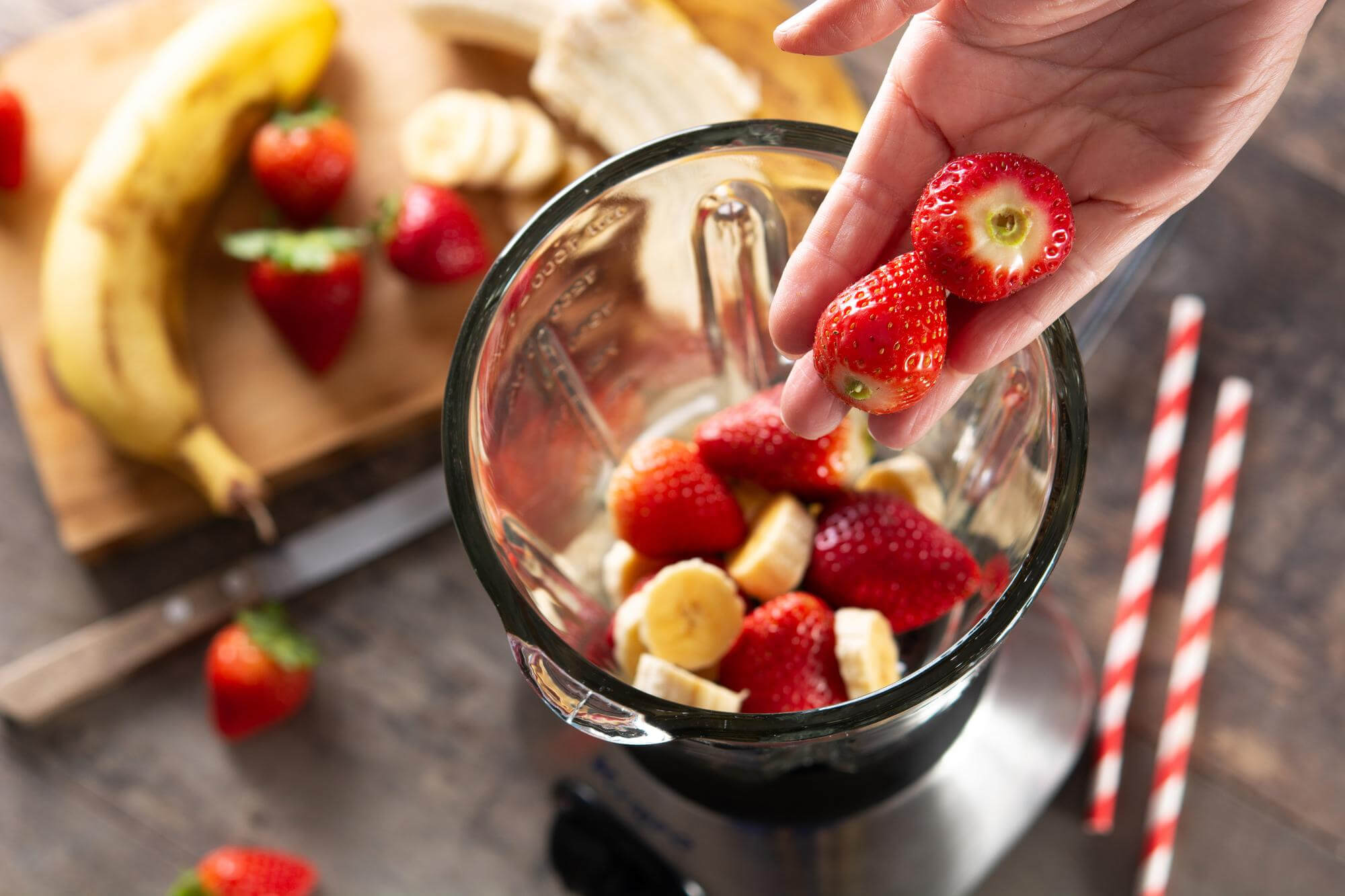 Strawberries and bananas in a blender.